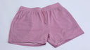 Pink mesh shorts with 'Gymshark' branding on a light gray background